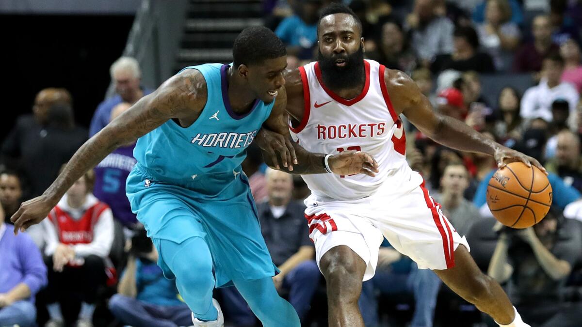 Hornets forward Dwayne Bacon tries to cut off a drive by Rockets guard James Harden during their game Friday.
