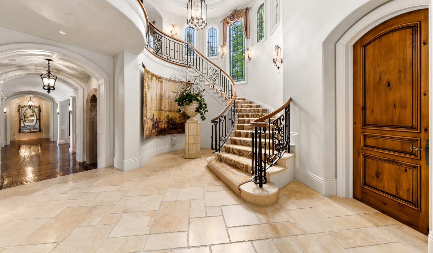 The white foyer leads to a staircase and a hallway.