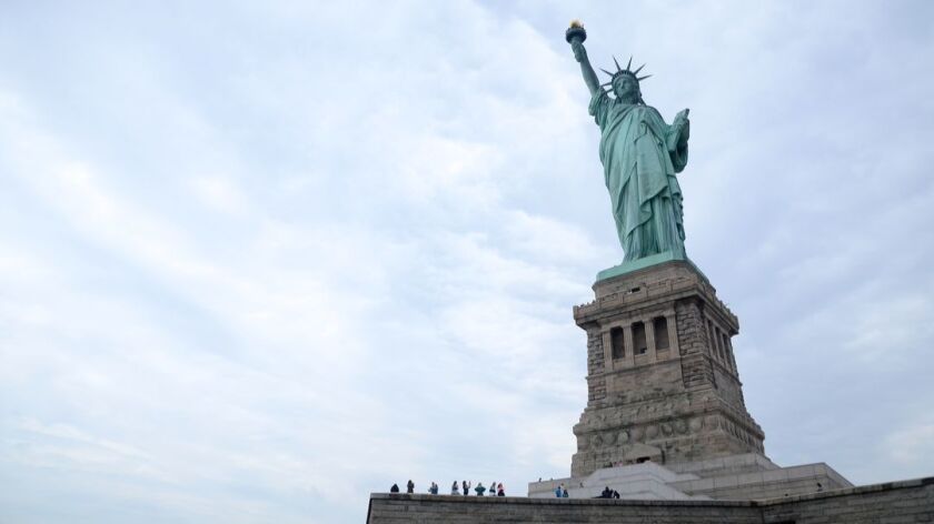 The Statue of Liberty, designed and built in France, was assembled on Bedloe's Island in 1886, six years before Ellis Island opened nearby as an immigrant processing facility.