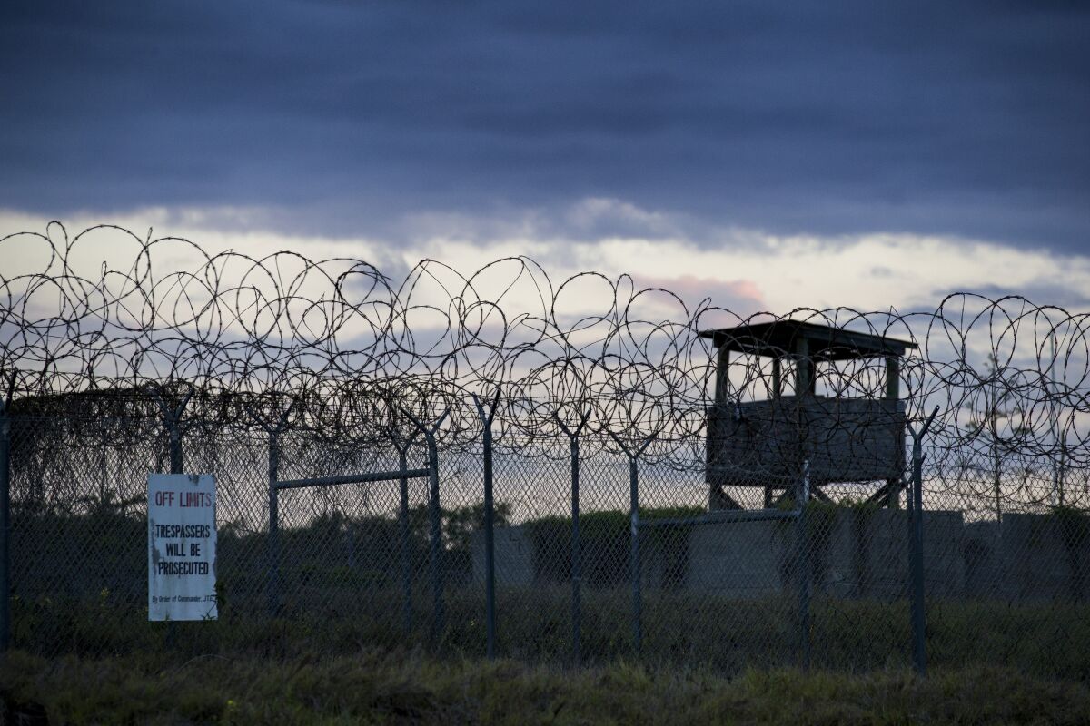 FILE - In this photo reviewed by U.S. military officials, the sun sets behind the closed Camp X-Ray detention facility, on April 17, 2019, in Guantanamo Bay Naval Base, Cuba. A Saudi prisoner at the Guantanamo Bay detention center who was suspected of trying to join the 9/11 hijackers has been sent back to his home country for treatment for mental illness. The Department of Defense says Mohammad Ahmad al-Qahtani was flown back to Saudi Arabia from the U.S. base in Cuba after a review board concluded he could be safely released after 20 years in custody. (AP Photo/Alex Brandon, File)
