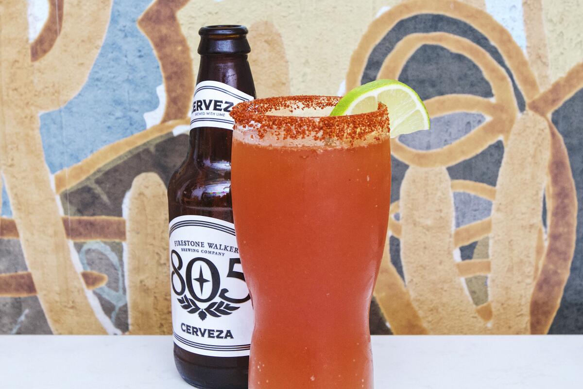 A photo of a michelada from Todos Santos, alongside a bottle of Firestone Walker Brewing Co.'s 805 Cerveza lager.