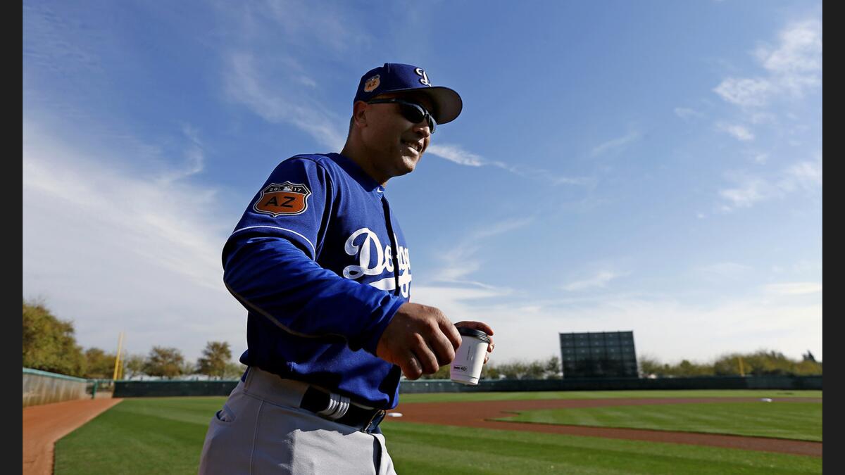 Dodgers Manager Dave Roberts arrives at the field for a spring-training practice at Camelback Ranch last month.