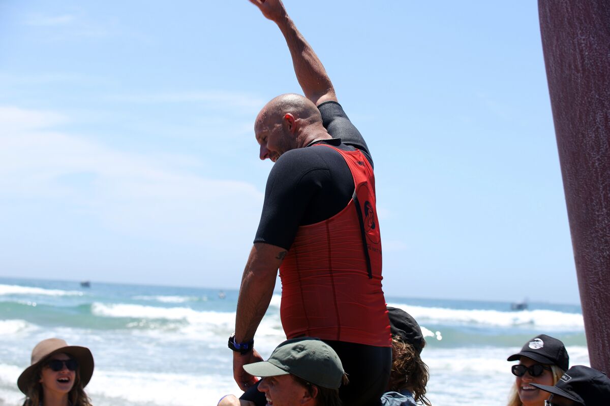 Taylor Jensen of San Diego raises his fist after winning the men's Duct Tape Invitational during the U.S. Open of Surfing.