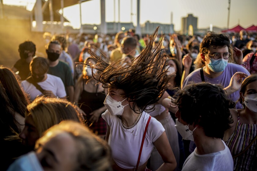 People dance during the Cruilla music festival in Barcelona, Spain, Friday, July 9, 2021. (AP Photo/Joan Mateu)