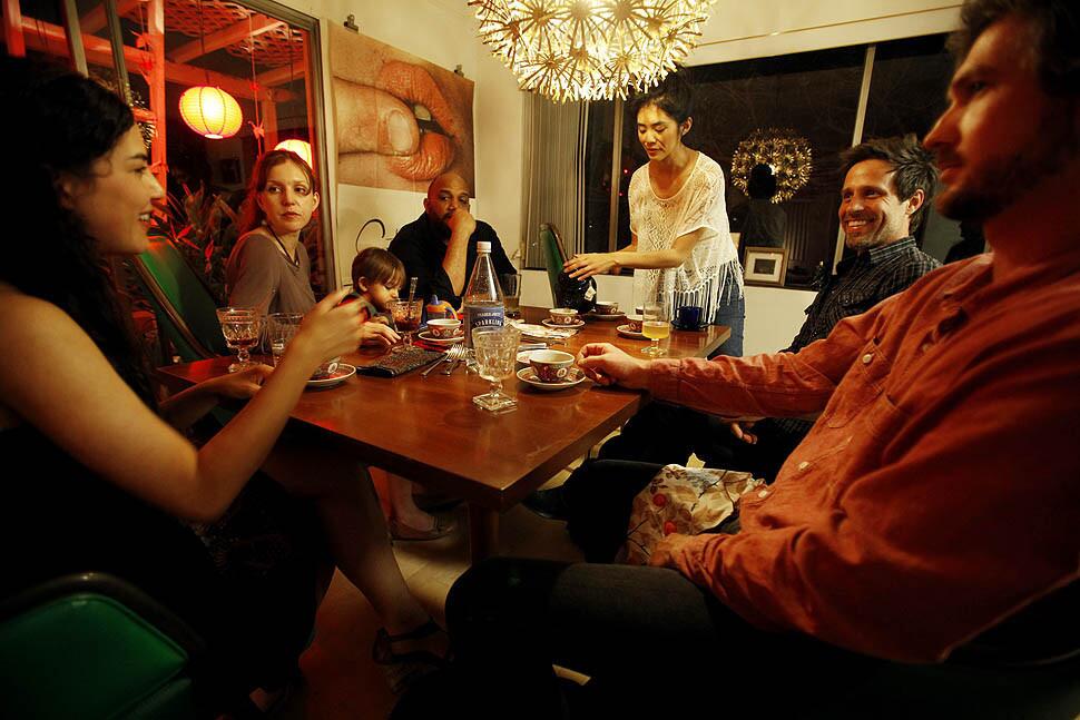 Three families enjoy dinner in a Silver Lake home -- from left, Melissa Vergara, Marissa Engel, Engel's son Mars Dixon, Eric Dixon, Carla Choy, Billy Czyzyk, and Keith Patterson. Marissa Engel of Hollywood wants to live in a more connected world. In a concept she calls supper surfing, she arranges for strangers to have dinner with strangers and perhaps start up friendships while breaking bread.