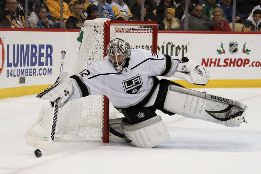 Los Angeles Kings goaltender Jonathan Quick clears the puck away from the net as he plays against the Pittsburgh Penguins during the second period of an NHL hockey game, Saturday, Dec. 14, 2019, in Pittsburgh. (AP Photo/Keith Srakocic)