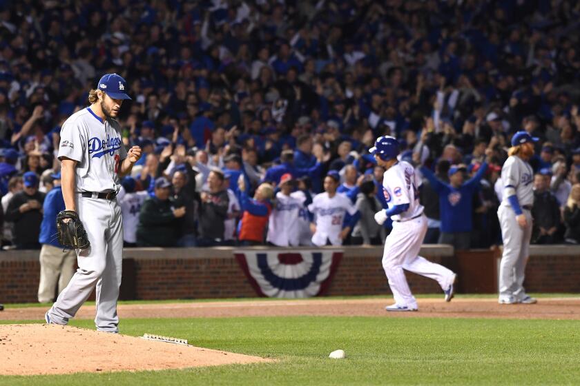 Dodgers pitcher Clayton Kershaw walks back to the mound as Cubs catcher Willson Contreras rounds the bases after his solo home run in the fourth inning of Game 6.