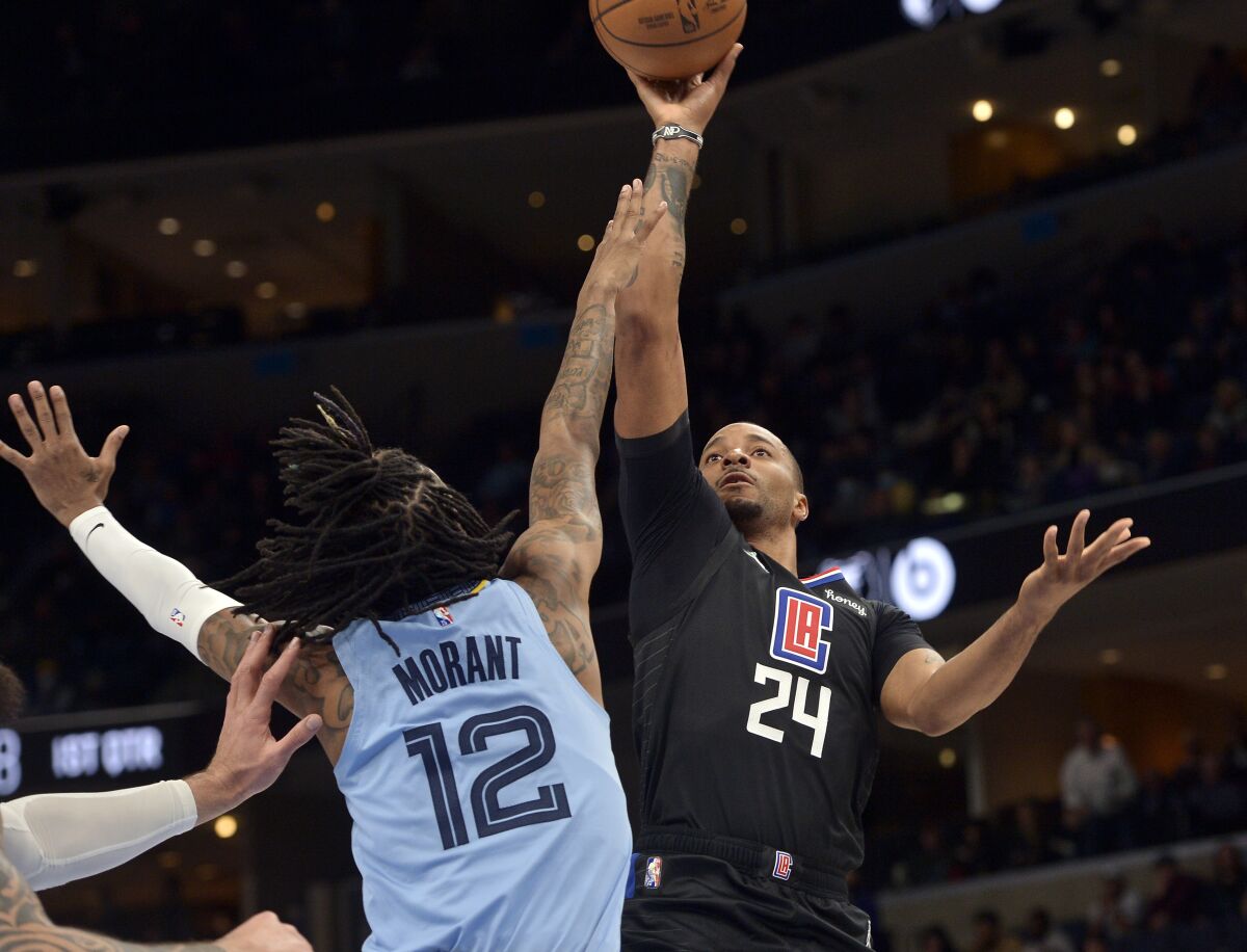 Los Angeles Clippers forward Norman Powell (24) shoots against Memphis Grizzlies guard Ja Morant (12) in the first half of an NBA basketball game Tuesday, Feb. 8, 2022, in Memphis, Tenn. (AP Photo/Brandon Dill)