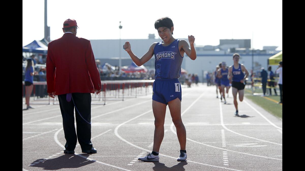Fountain Valley High's Yuki Watanabe reacts after finishing first in the boys' 1600-meter race of the Surf League finals at Los Alamitos on Friday.