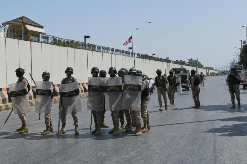 Paramilitary soldiers take positions at the U.S. Consulate after protesters stormed the building in Karachi, Pakistan, Sunday, March 1, 2026. (AP Photo/Ali Raza)