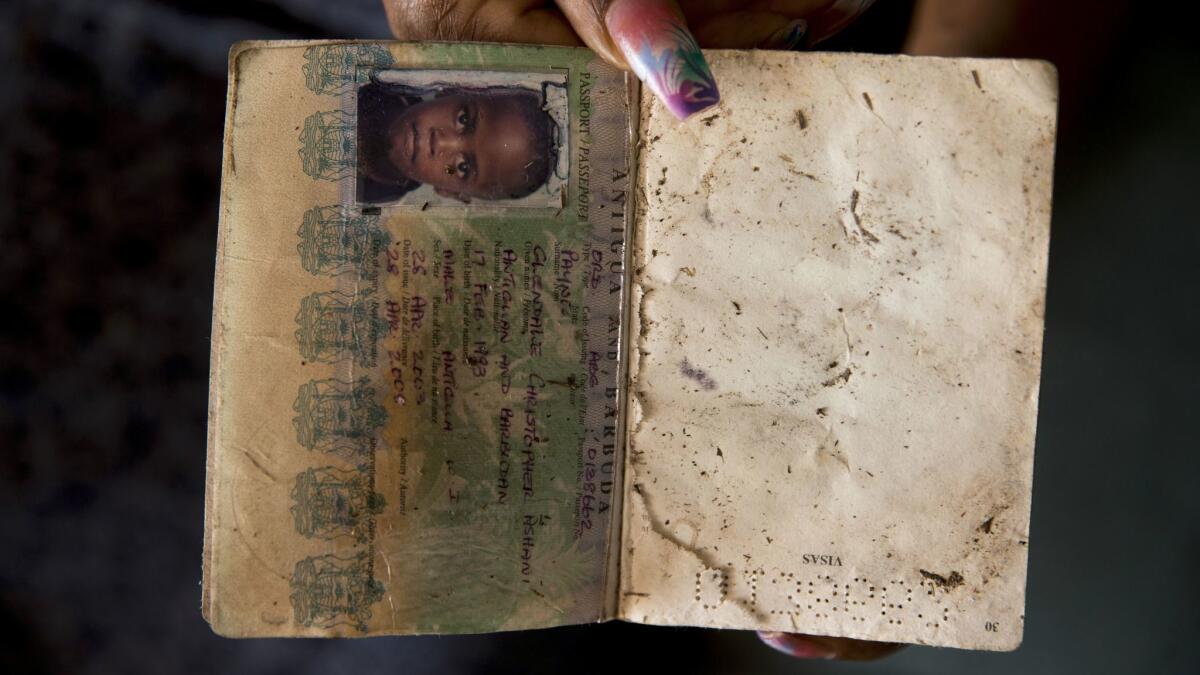 Gloria Cephas holds the only passport she could salvage from her family home on Barbuda.