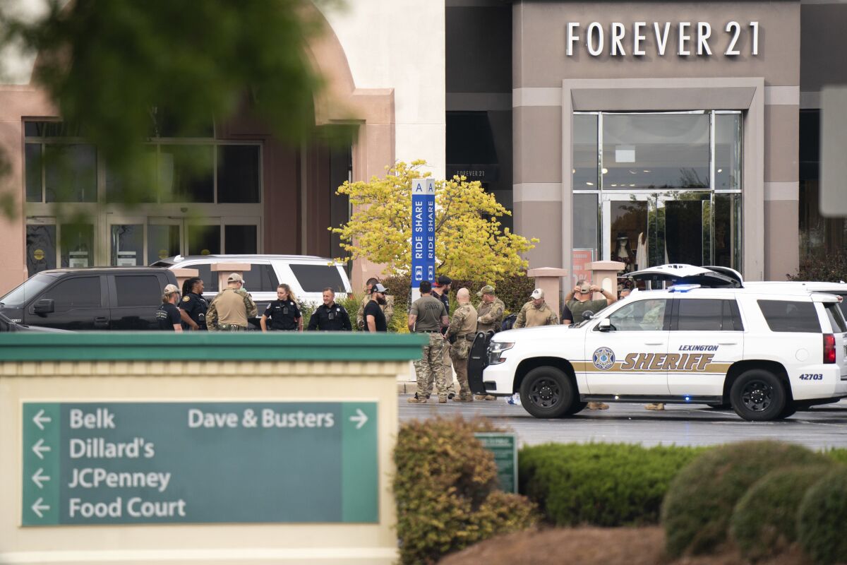 FILE - Members of law enforcement gather outside Columbiana Centre mall in Columbia, S.C., following a shooting, April 16, 2022. Authorities in South Carolina say they are investigating shooting at a club in Hampton County early Sunday, April 17, 2022 that left at least nine people injured. It was the second mass shooting in the state in as many days. (AP Photo/Sean Rayford)