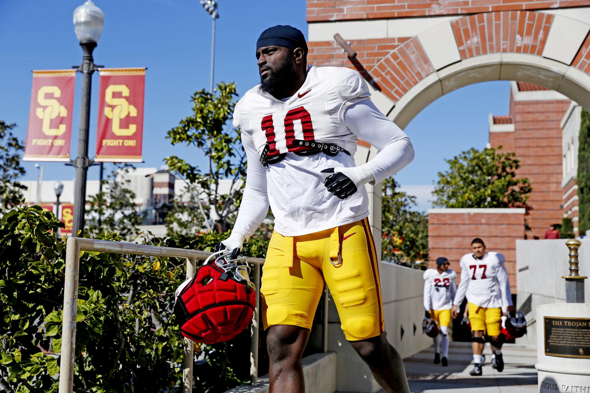 Rush end Jamil Muhammad makes his way to the practice field on the USC campus in March.