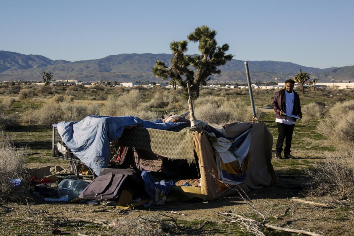 Derrick Chambers checks out a homeless encampment in the Lancaster desert during the annual homeless census in January.