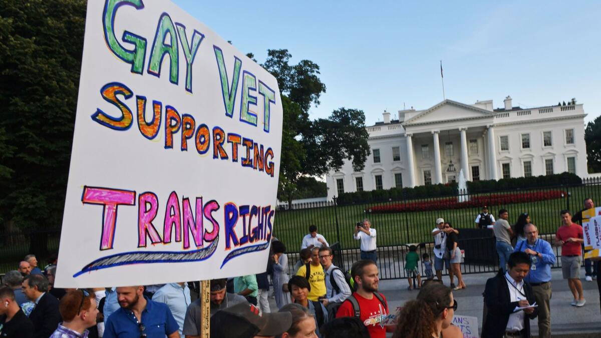 Protesters gathered in front of the White House on July 26 to respond to President Trump's call for a ban on transgender troops.