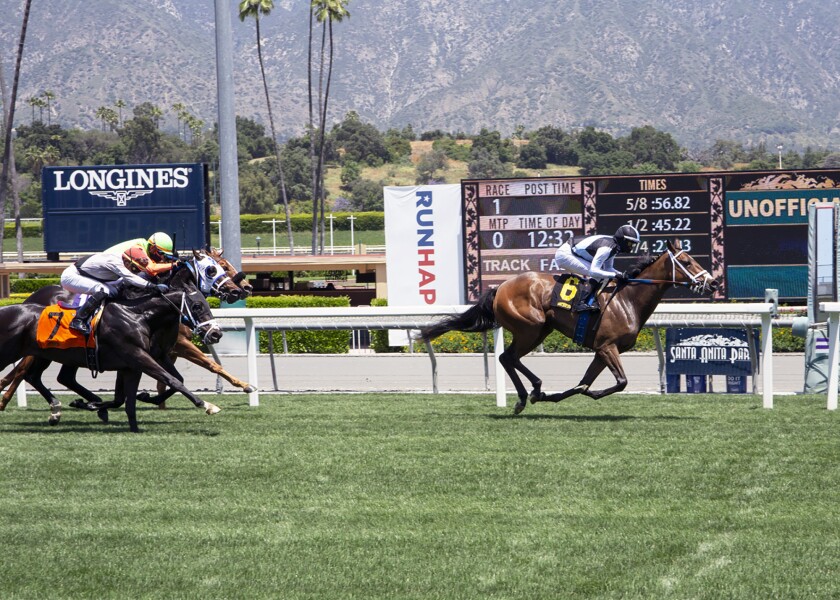 She's So Special, right, with Flavien Prat aboard, wins the first horse race at Santa Anita Park on Friday.