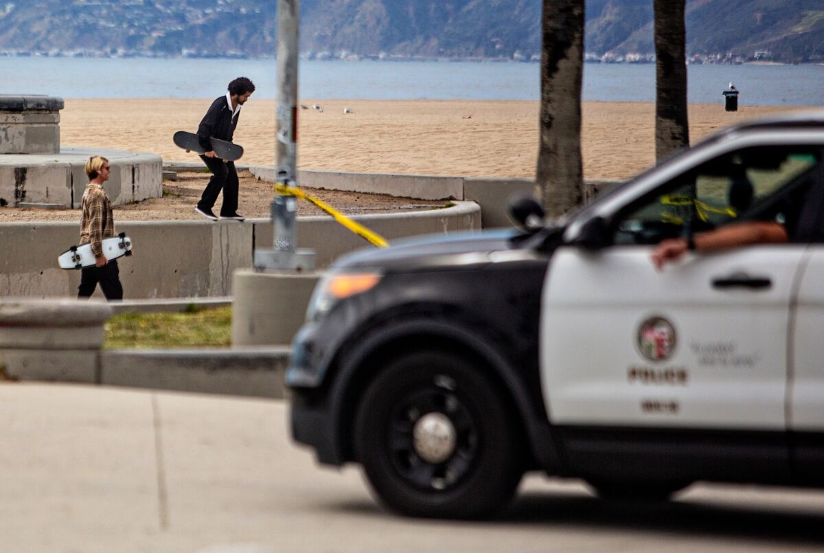 LAPD clears people from using the skate park at Venice Beach during the coronavirus pandemic on Monday in Venice Beach.