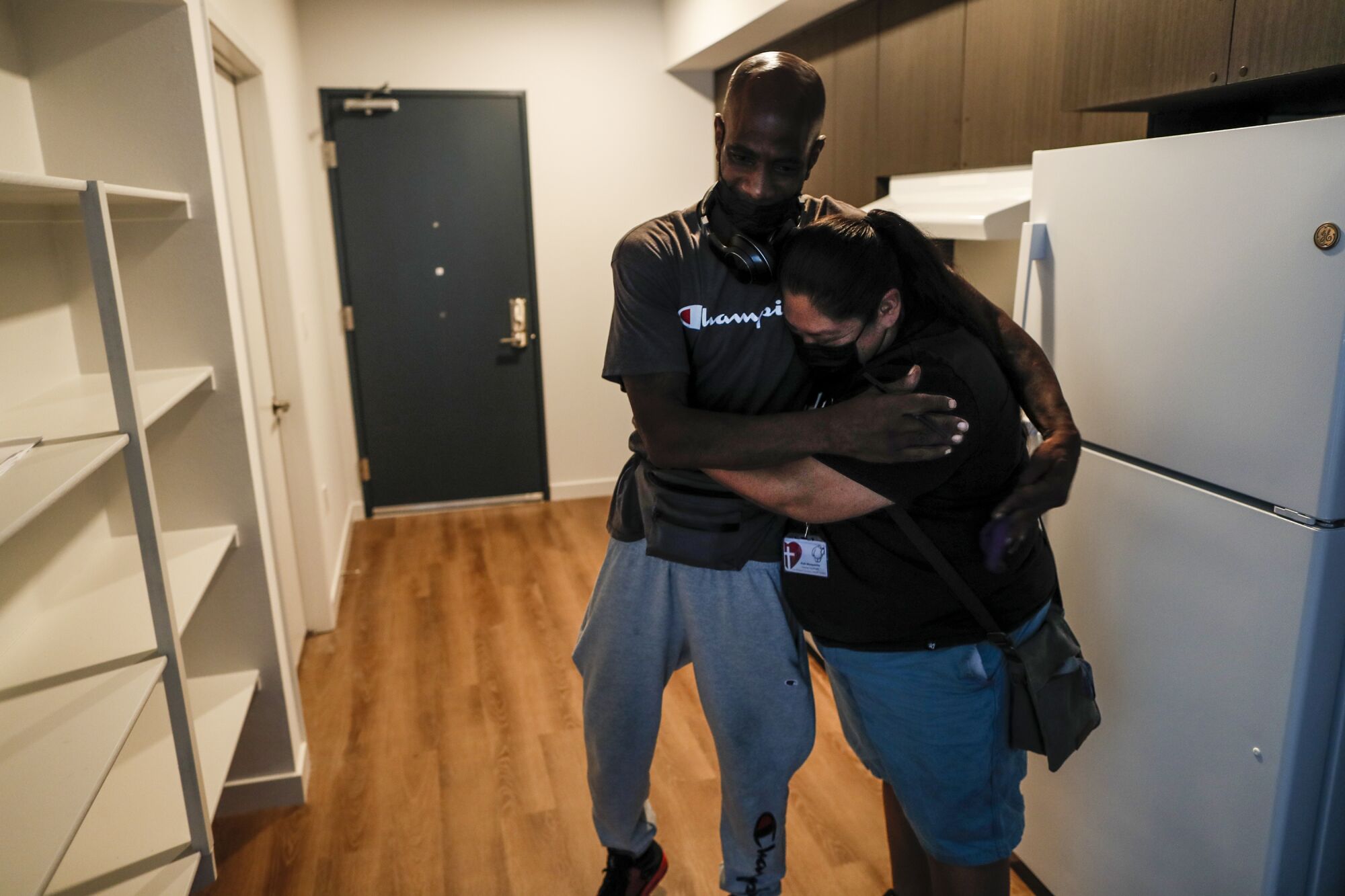 L.A. Christian Health Center Housing coordinator Ruth Morquecho embraces Donald Winston 