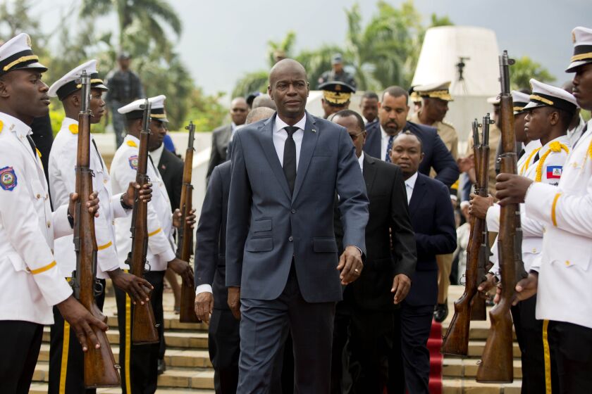 FILE - In this April 7, 2018, file photo, Haiti's President Jovenel Moise, center, leaves the museum during a ceremony marking the 215th anniversary of revolutionary hero Toussaint Louverture's death, at the National Pantheon museum in Port-au-Prince, Haiti. Moïse was assassinated after a group of unidentified people attacked his private residence, the country’s interim prime minister said in a statement Wednesday, July 7, 2021. (AP Photo/Dieu Nalio Chery, File)