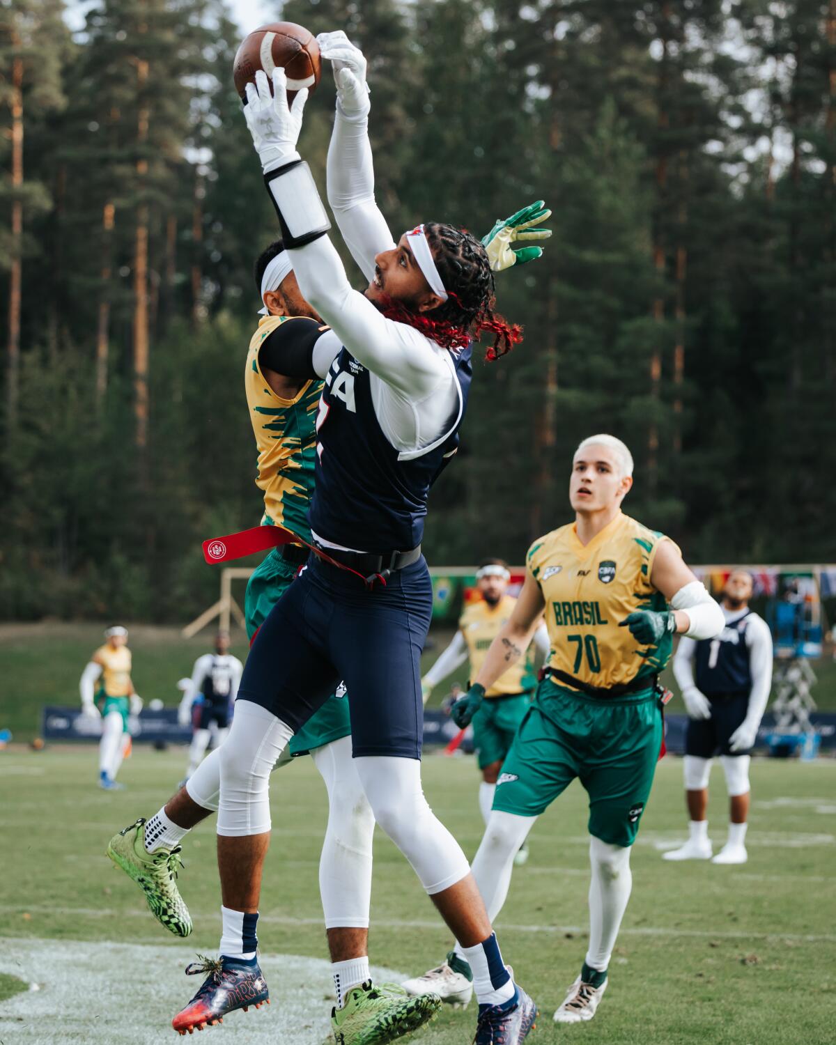 Darrell Doucette jumps in front of a defender to catch a touchdown pass.