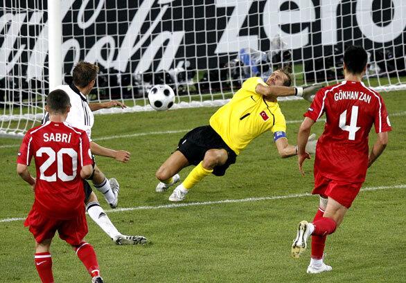Germany's Philipp Lahm, center left, scores the decisive goal past Turkey's Rustu Recber, center right, during the semifinal match between Germany and Turkey in Basel, Switzerland, at the Euro 2008 European Soccer Championships. Germany defeated Turkey 3-2.