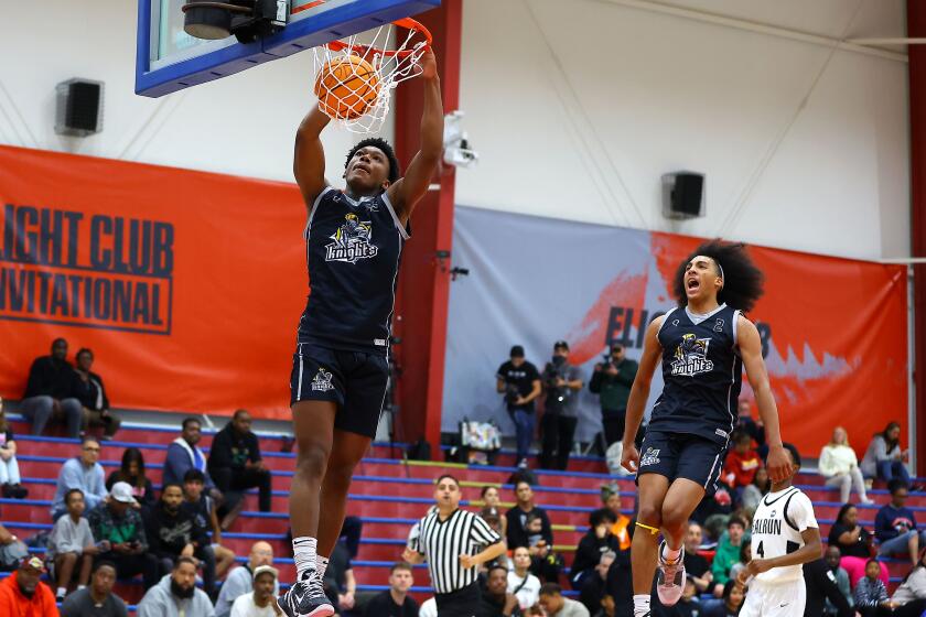 Mercy Miller of Sherman Oaks Notre Dame dunks and Lino Mark celebrates.