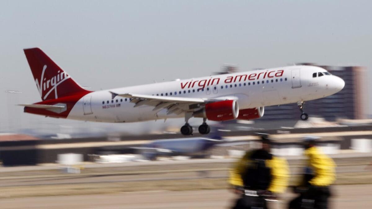 A Virgin America flight lands at Dallas Fort Worth International Airport.