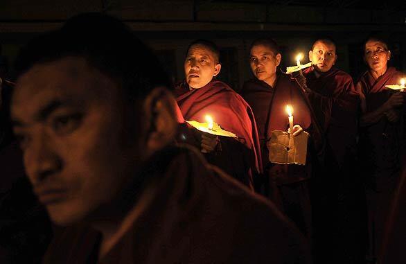 Tibetan Buddhist nuns, in background, participate in a candlelight vigil for the victims of the Mumbai terrorist attacks in Dharmsala, India. A series of attacks that started late Wednesday in Mumbai killed more than 170 people.