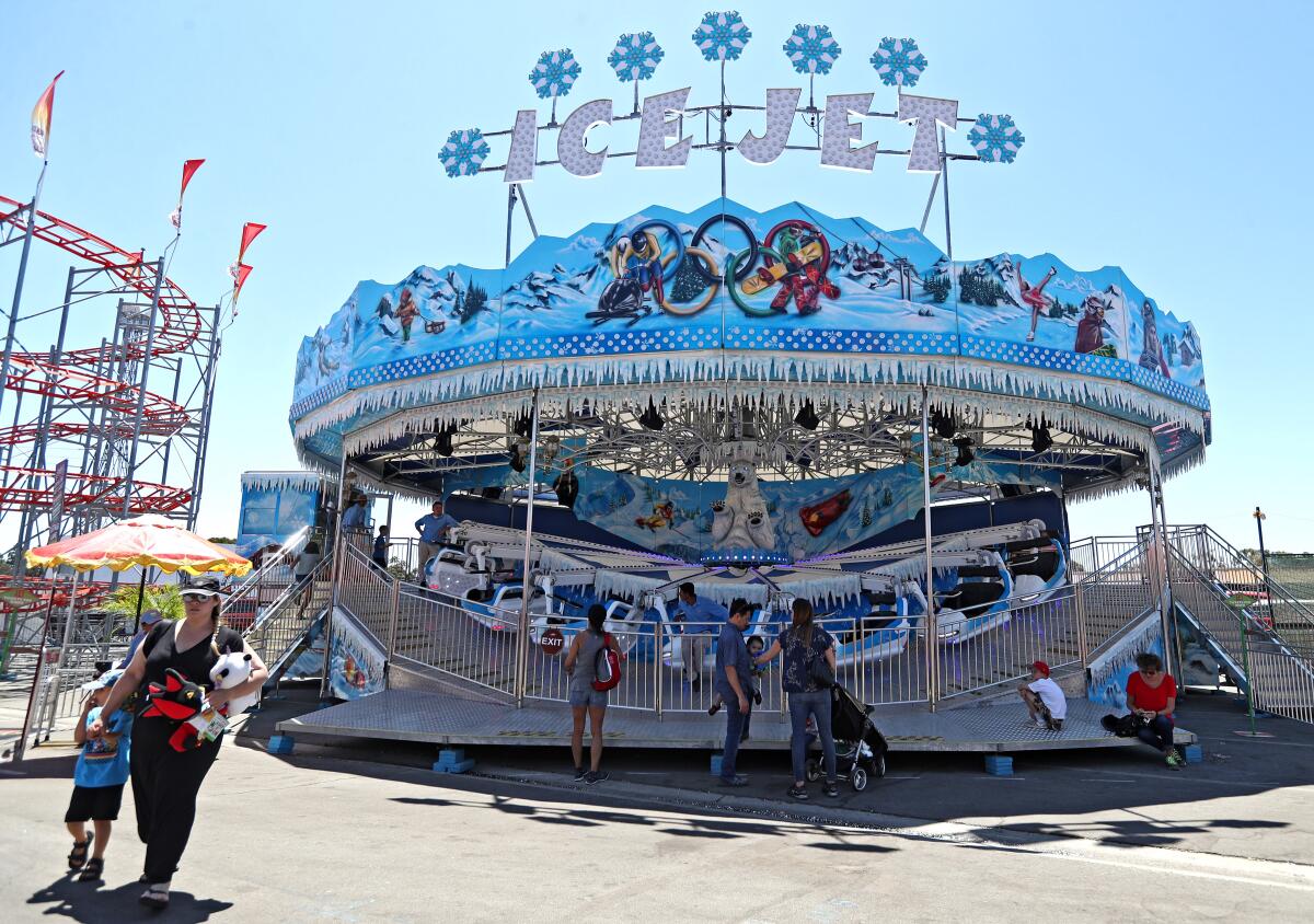 Riders wait to board the Ice Jet ride at the 2019 Orange County Fair in Costa Mesa. The Fair Board will meet later this month to discuss whether to cancel this year's fair because of the coronavirus pandemic.