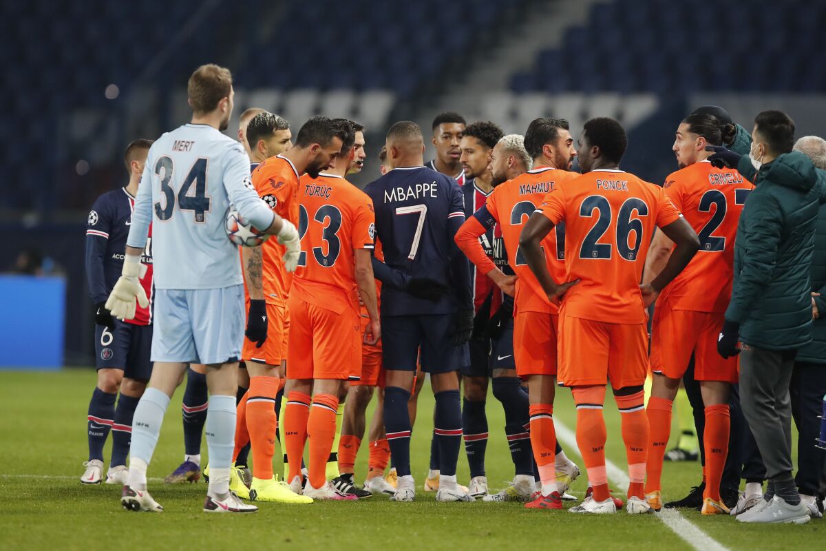 Players of Paris Saint Germain and Istanbul Basaksehir leave the pitch, after an argument between the Turkish players and the fourth referee during the Champions League group H soccer match between Paris Saint Germain and Istanbul Basaksehir at the Parc des Princes stadium in Paris, Tuesday Dec. 8 , 2020. (AP Photo/Francois Mori)