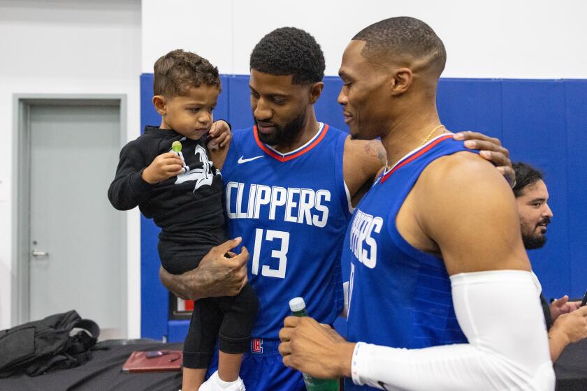 Playa Vista, CA - October 02: Russel Westbrook greets Paul George and his son Paul Vuk during LA Clippers media day on Monday, Oct. 2, 2023 in Playa Vista, CA. (Jason Armond / Los Angeles Times)