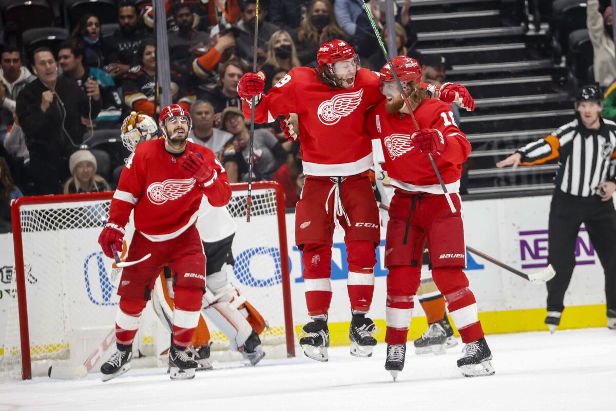 Detroit Red Wings forward Tyler Bertuzzi, center, celebrates his goal with defenseman Marc Staal, right during the second period of an NHL hockey game against the Anaheim Ducks, Sunday, Jan. 9, 2022, in Anaheim, Calif. (AP Photo/Ringo H.W. Chiu)