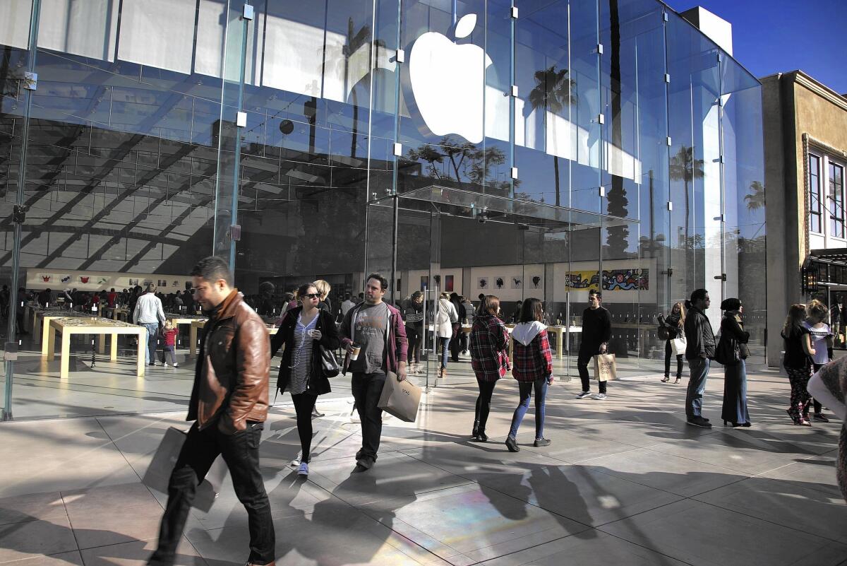 Apple posted a profit for the October-December quarter of $18 billion, up almost 38% from a year earlier. Above, an Apple Store in Santa Monica.