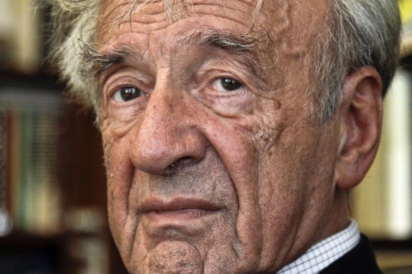 FILE - In this Sept. 12, 2012, photo Elie Wiesel is photographed in his office in New York. Israel's Yad Vashem Holocaust Memorial says Elie Wiesel has died at 87. Romanian police on Saturday, Aug. 4, 2018 began an investigation after anti-Semitic graffiti appeared on the house of late Nobel laureate Elie Wiesel in northwest Romania. The probe was launched Saturday after comments were scrawled overnight on Wieselâs small house, a protected historical monument_ in the town of Sighetu Marmatiei. (AP Photo/Bebeto Matthews, File)