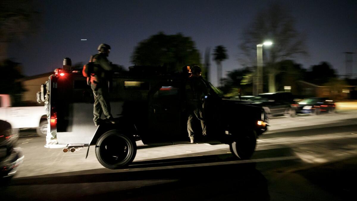ATF agents roll out after conducting a raid at a home in Granada Hills.
