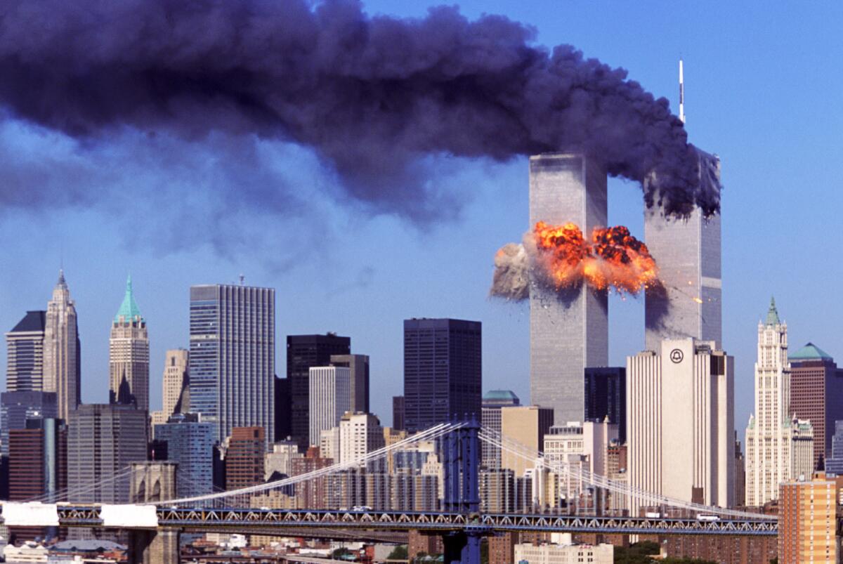 An explosion rips through the South Tower of the World Trade Towers after the hijacked United Airlines Flight 175 crashed into it Sept, 11, 2001. The North Tower is shown burning after American Airlines Flight 11 crashed into the tower at 8:45 a.m.