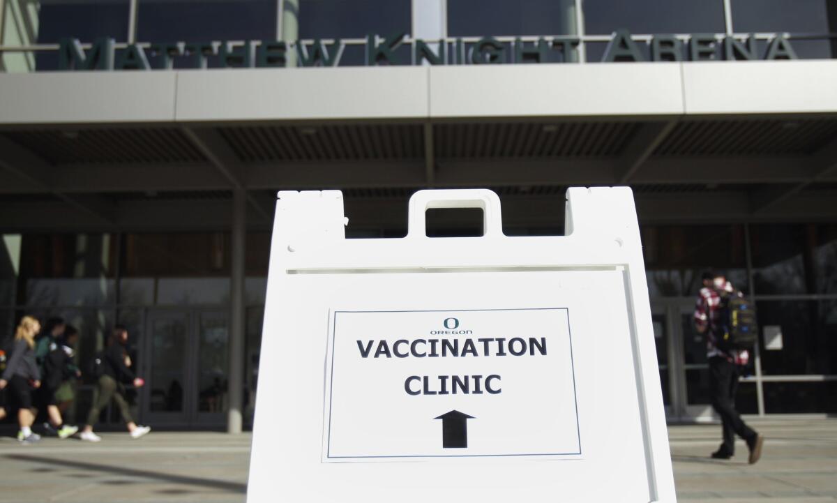In this Feb. 24 photo, a sign directs students to a clinic at Matthew Knight Arena on the University of Oregon campus in Eugene, Ore., where students could get vaccinated against an infection that can cause a form of meningitis.