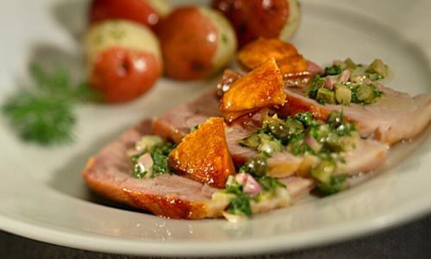 DIFFERENT: Roast pork is topped with a green sauce made with shallots, vinegar, capers and cornichons.