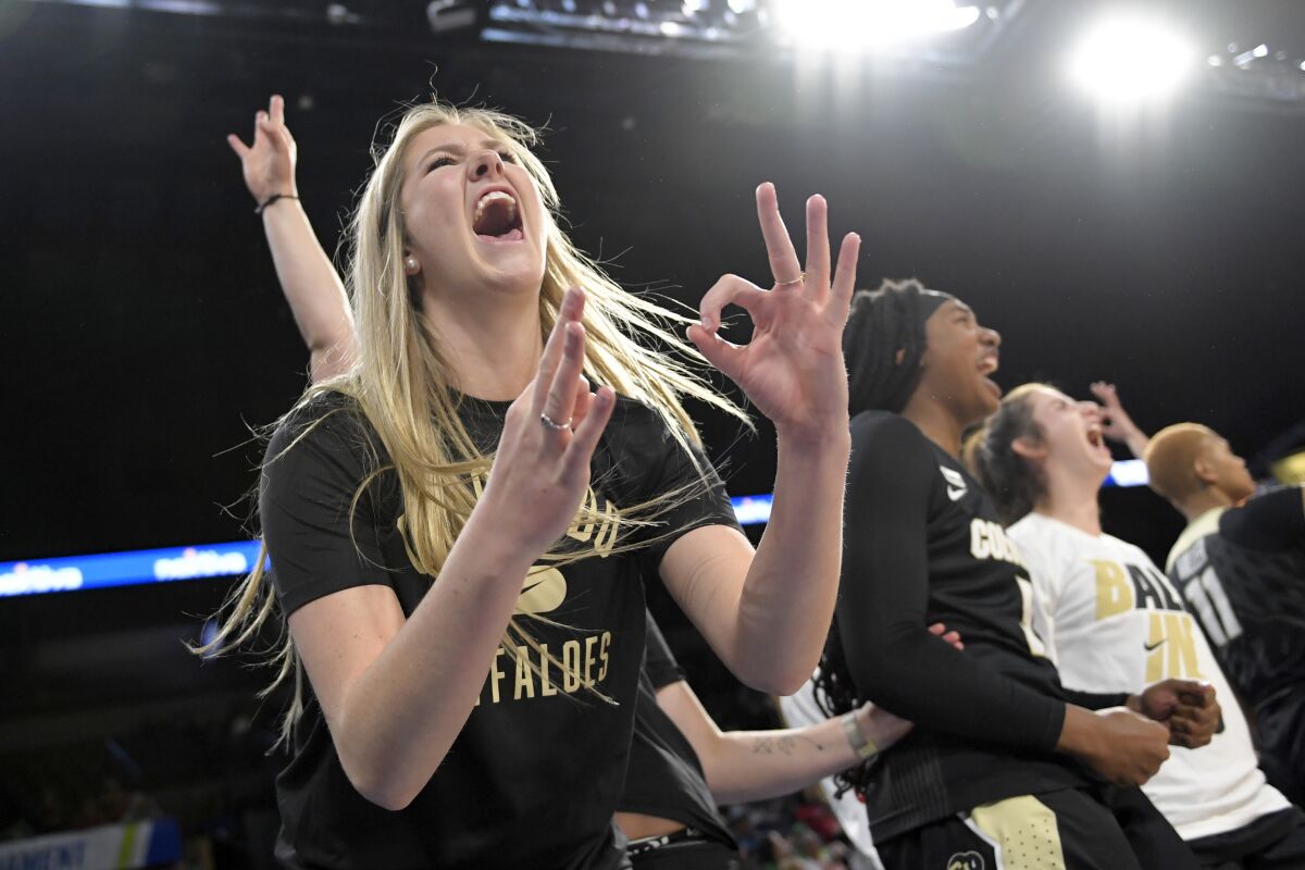 Colorado's Maura Singer reacts from bench after a 3-point basket against Arizona during an NCAA college basketball game in the quarterfinals of the Pac-12 women's tournament Thursday, March 3, 2022, in Las Vegas. (AP Photo/David Becker)