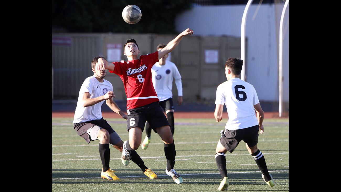 Burroughs High School soccer player #6 Xavier Iniguez controls the ball during game vs. Hoover High School, at the Tornadoes home field in Glendale on Tuesday, Dec. 12, 2017.