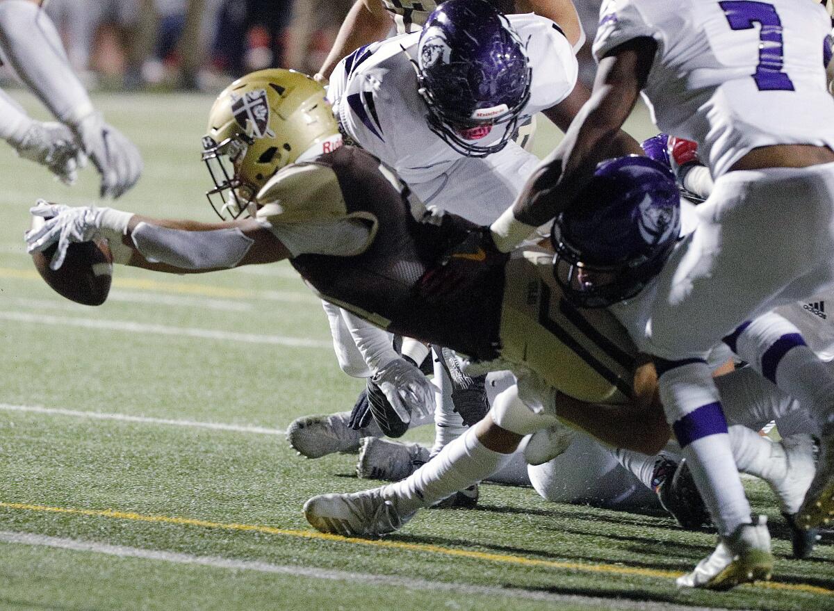 St. Francis' Kevin Armstead stretches forward over the goal line to score a touchdown against Cathedral in an Angelus League football game Friday.