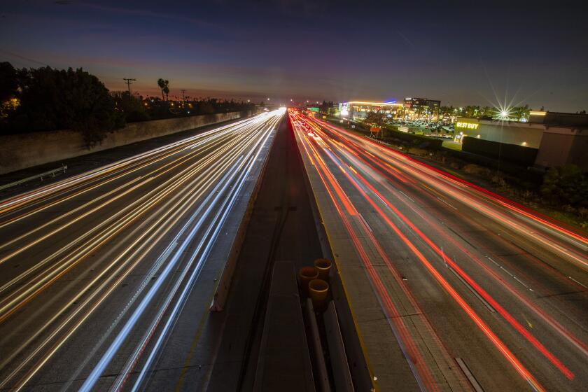 COSTA MESA, CALIF. -- WEDNESDAY, DECEMBER 11, 2019: A long exposure of cars traveling on 405 freeway at dusk in Costa Mesa, Calif., on Dec. 11, 2019. (Allen J. Schaben / Los Angeles Times)