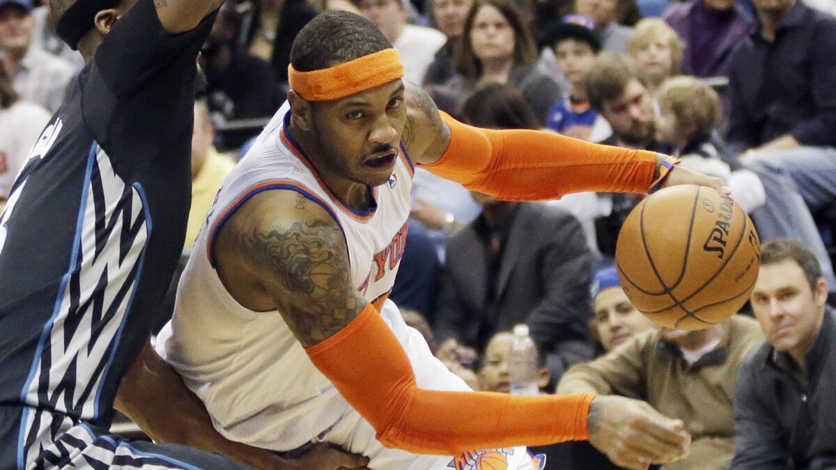 New York Knicks forward Carmelo Anthony, right, tries to drive past Minnesota Timberwolves forward Dante Cunningham during a game in March. The Lakers have expressed interest in signing Anthony.