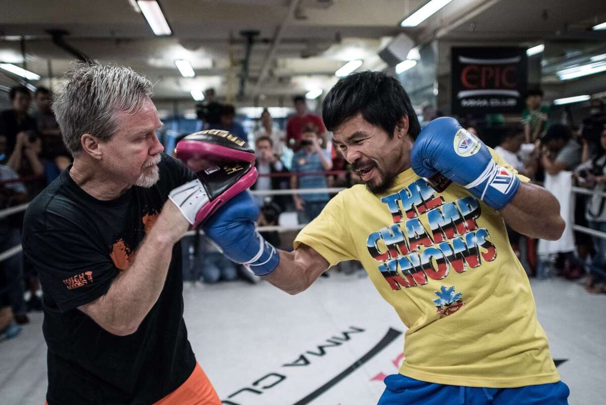 Manny Pacquiao, right, trains with Freddie Roach during a media call in Hong Kong on Oct. 27.