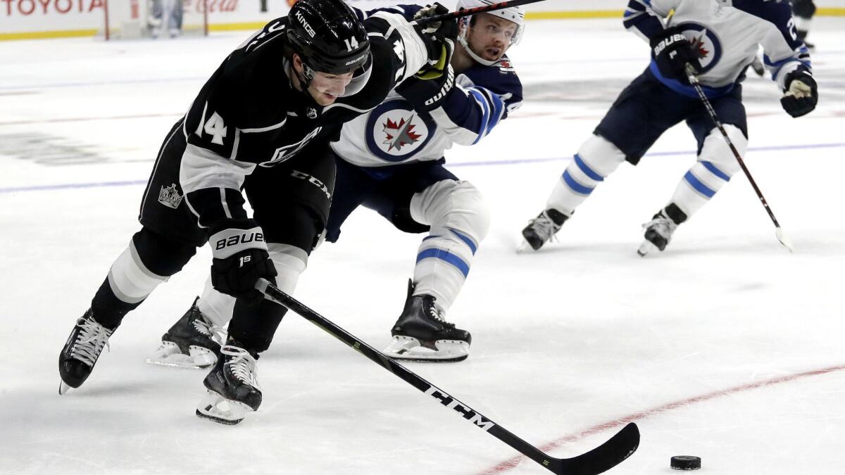 Kings left wing Brendan Leipsic battles Jets defenseman Josh Morrissey for possession of the pucks during a game Dec. 18.