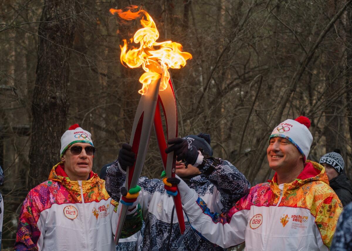 The Olympic torch continues its relay in Novosibirsk, about 1,750 miles east of Moscow, on Friday. Advertising spending is expected to rise more than 5% next year, in part because of the Winter Olympics in Sochi, Russia.