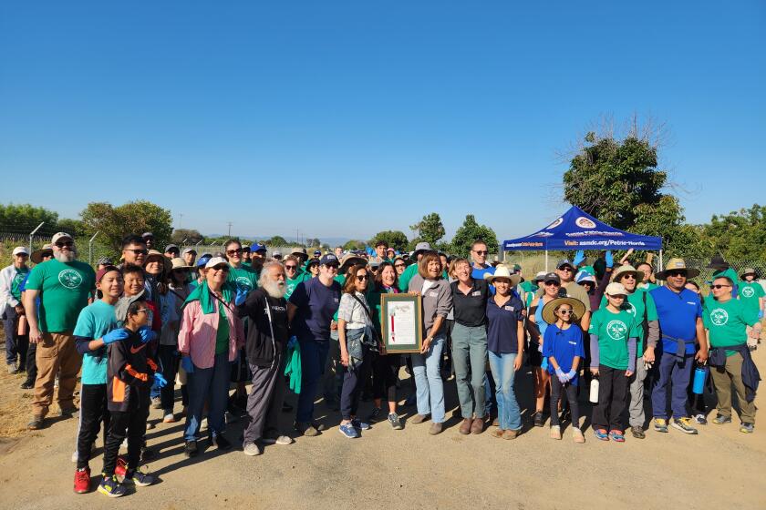 Assemblywoman Cottie Petrie-Norris (D-Irvine), left of center, presents a proclamation recognizing Second Harvest Food Bank of Orange County as the Nonprofit of the Year.