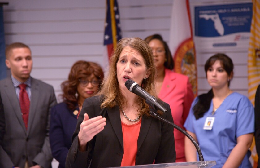 Health and Human Services Secretary Sylvia Mathews Burwell talks about enrollment in Obamacare at a recent event in Jacksonville, Fla. The Congressional Budget Office reported Monday that the cost of the program will be significantly less than previous projections.