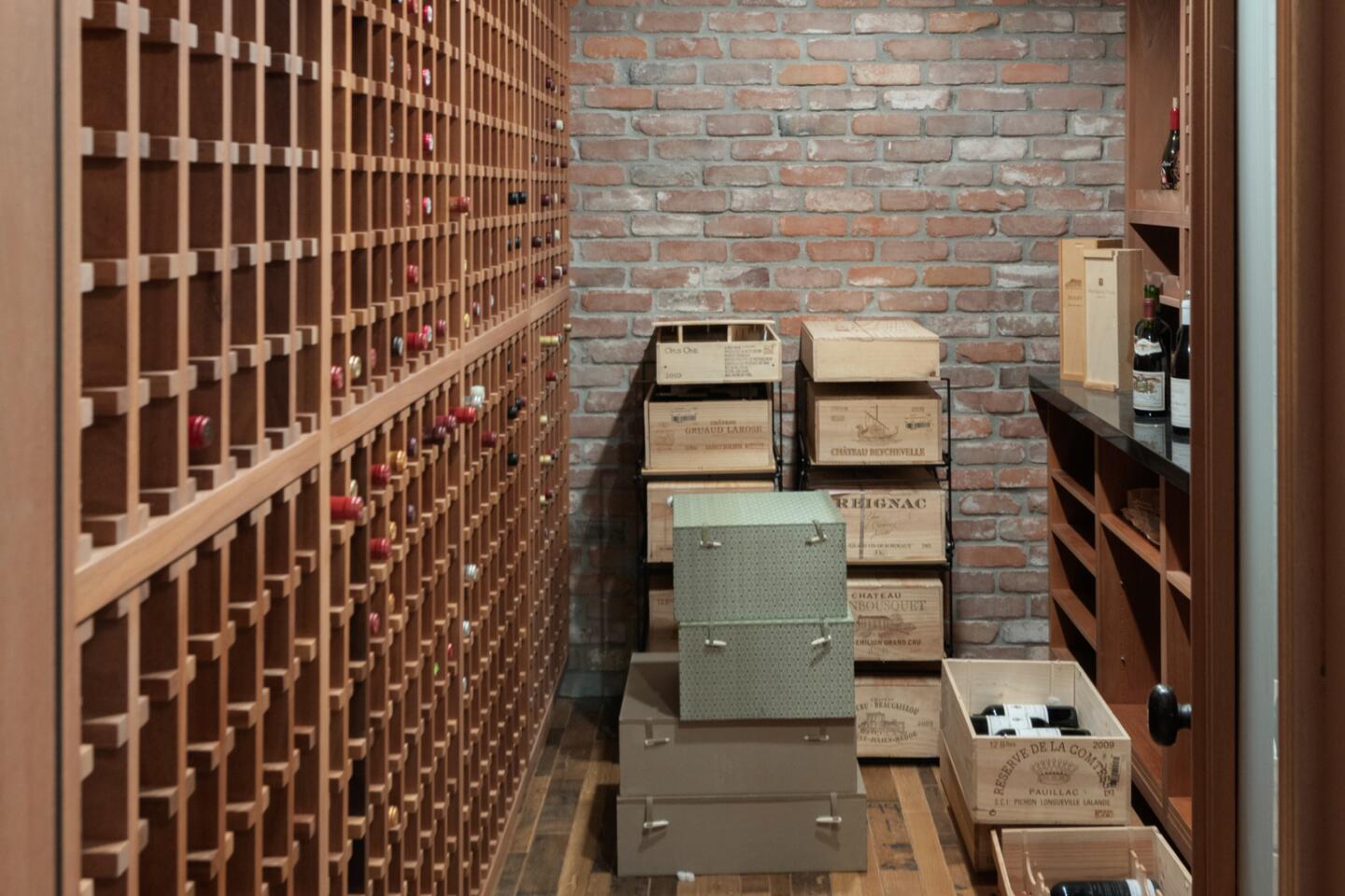 Wine racks cover one wall and brick another.