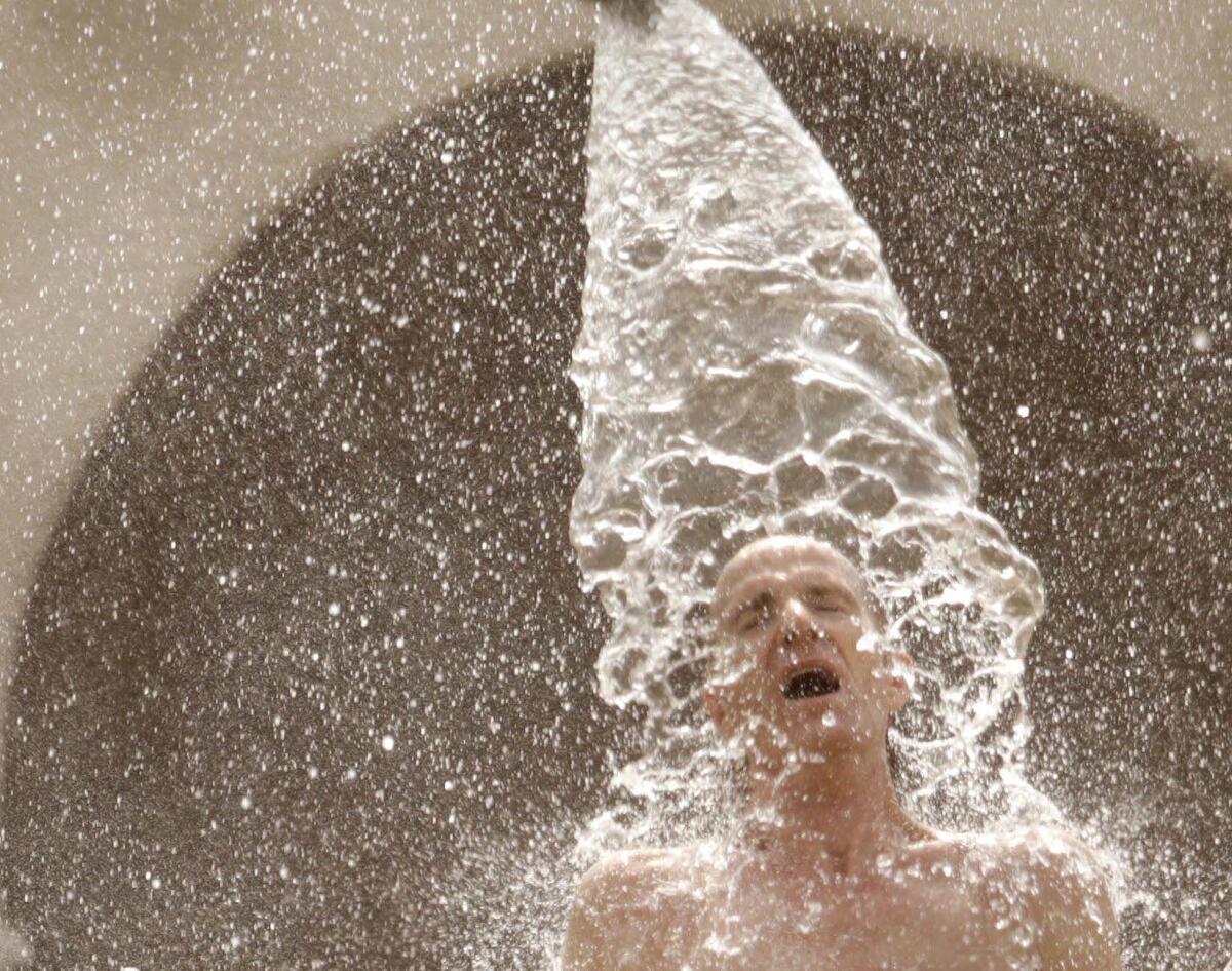Water pours over a man's head